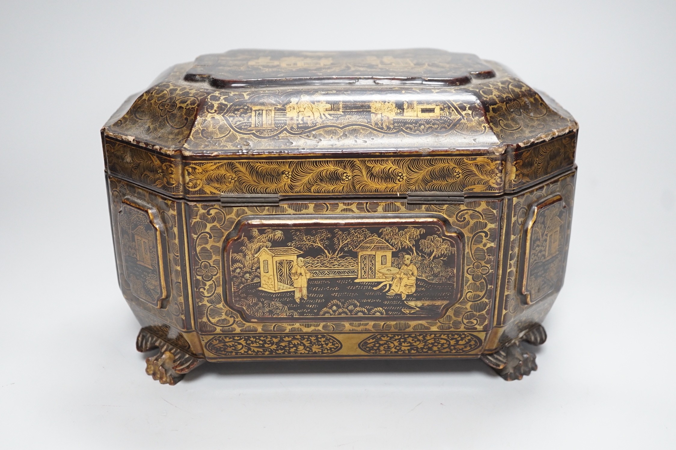 A 19th century Chinese chinoiserie lacquered sarcophagus form tea caddy, pewter lined interior with bone handles, 23cm